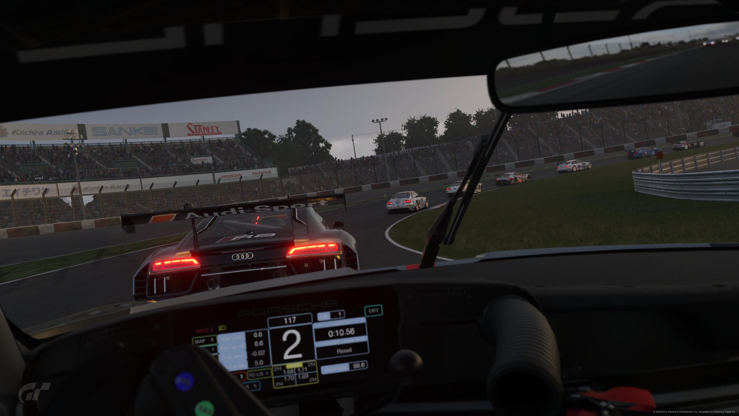 GT7 Porsche cockpit POV chasing an Audi R8 GT3 at Suzuka dusk, dashboard delta and lap timer visible