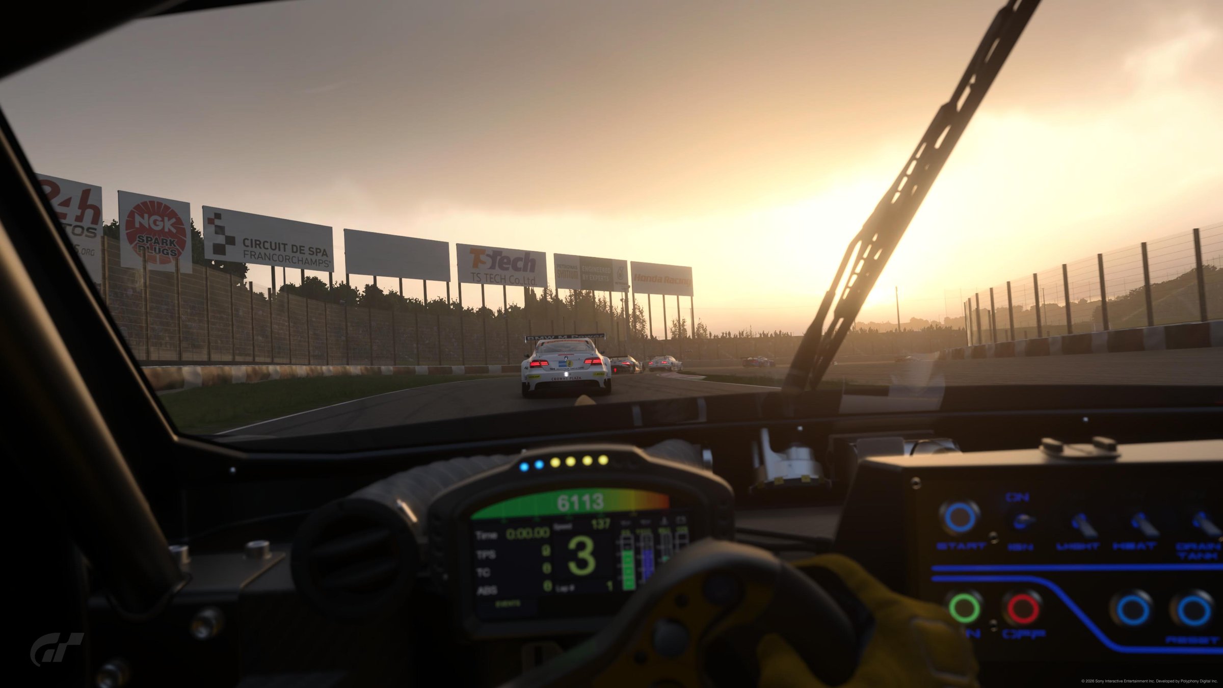GT7 Toyota cockpit POV at Spa Francorchamps in golden sunset, digital dash showing lap time, fuel and gear — endurance race feel