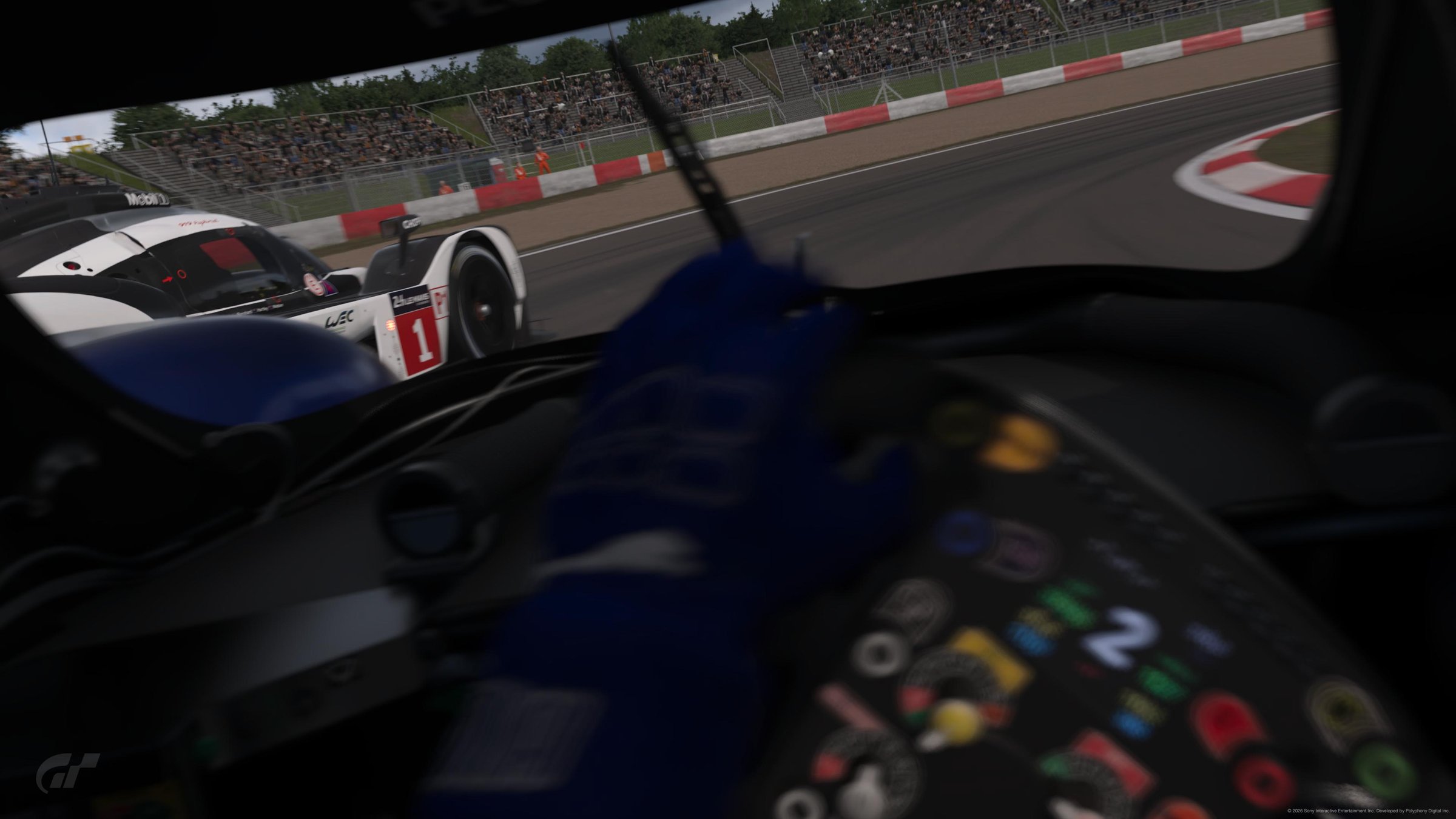 GT7 cockpit POV with a blue racing glove on the wheel, chasing the #1 WEC Porsche prototype at Nürburgring, multifunction wheel controls in focus
